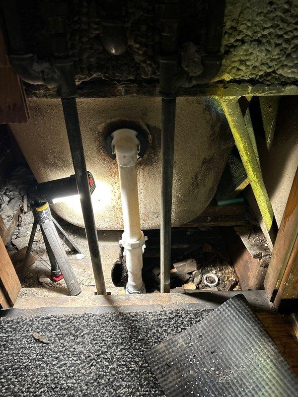 Completed repair of deteriorated plumbing system identified during initial assessment by Jared. Work included replacement of corroded drain assembly in bathroom sink which showed significant mineral buildup and staining. Additionally, addressed PVC drainage issues in the utility access area where vertical pipes showed signs of wear and surrounding concrete exhibited deterioration.
