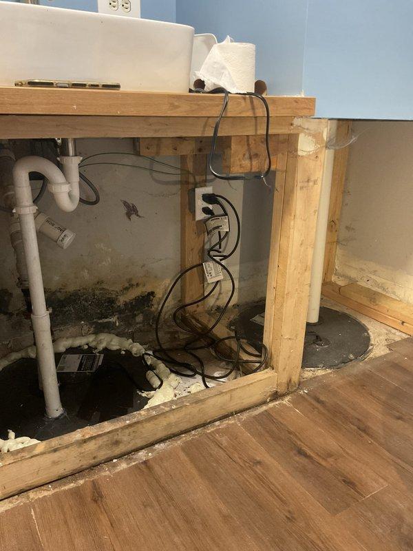Conducted inspection of existing sump pump system requiring replacement. Identified significant moisture issues evidenced by mold growth on surrounding surfaces and water damage to adjacent wall areas. Recommended complete replacement of current sump pump along with remediation of water damage to prevent further structural deterioration.