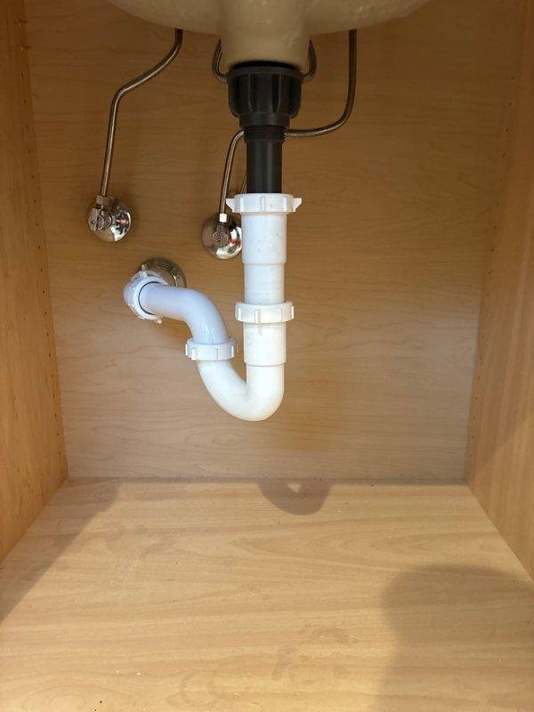 Responded to service call for disconnected drain connector that had fallen into pipe affecting sink and bath drainage. Upon inspection, found and retrieved the detached connector from the plumbing system. Successfully reattached the drain connector to both fixtures, securing all PVC P-trap components and verifying proper alignment of the drain assembly. Tested drainage system after repair with no leaks observed and proper water flow confirmed.