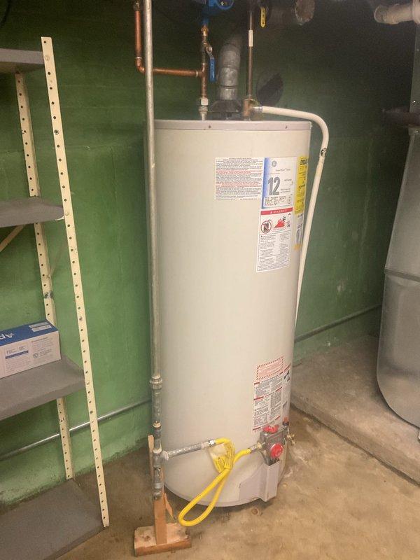 Responded to a service call for a water heater leaking from the base. Upon inspection, found the tank had failed with visible water damage to surrounding floor and walls. Replaced the existing water heater with appropriate size unit, installed new supply lines, and tested system for proper operation and absence of leaks.