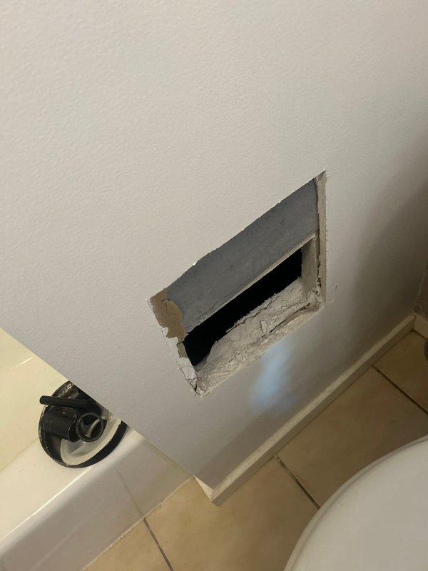 Accessed bathroom plumbing through wall access panel to perform scheduled angle stop replacement. Inspected ceiling-mounted shower valve assembly which showed signs of uneven installation with sealant deterioration around the mounting plate. Completed both the angle stop replacement and shower valve maintenance during scheduled building shutdown.