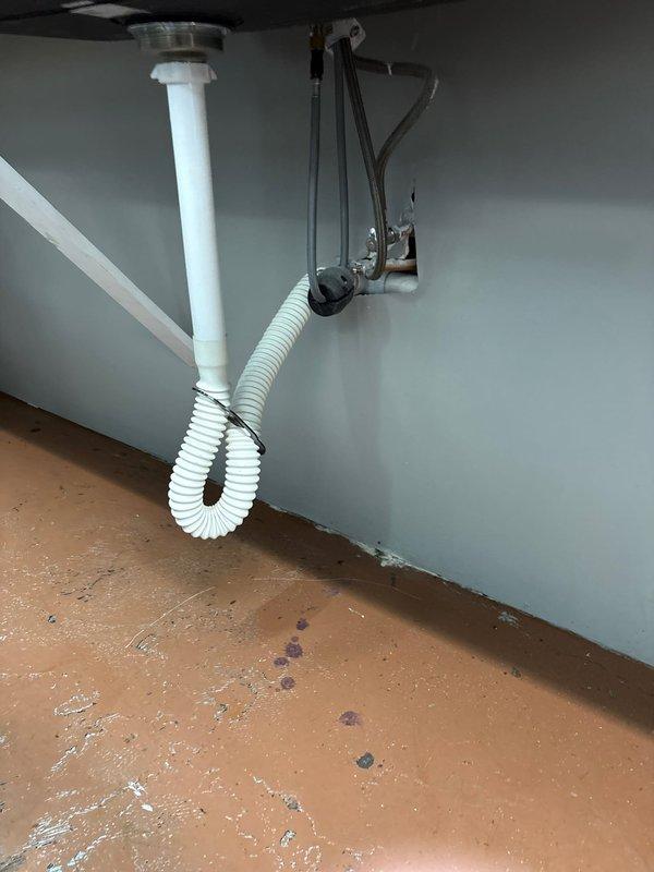 Installed customer-supplied sink in commercial location, which included mounting the fixture to the wall and connecting the white PVC drain assembly with proper fittings. Completed installation of the water supply lines with chrome-finished components and ensured all connections were secure and leak-free.