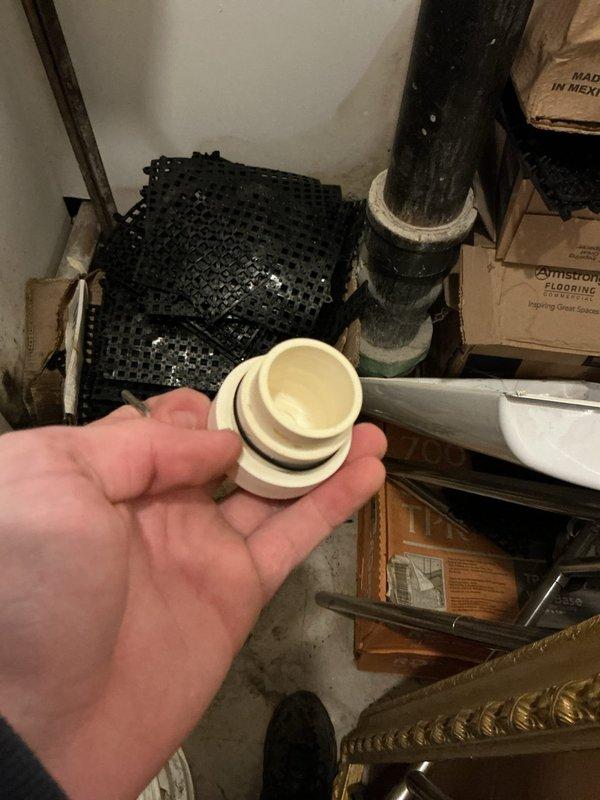 Responded to service call for tankless water heater displaying error code E110 with no hot water output. Inspection revealed significant corrosion and mineral buildup at drain pipe connection causing system failure. Replaced damaged valve assembly and pipe fitting, cleaned mineral deposits from affected components, and restored proper water flow. System tested successfully with error code cleared.