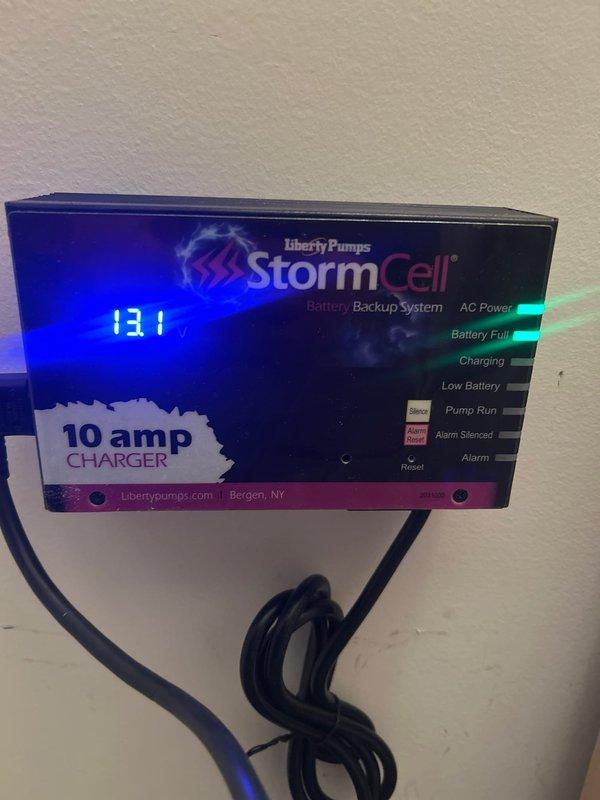 Inspected Liberty Pumps StormCell Battery Backup System that was previously installed by another contractor. System appears to be functioning properly with AC power and battery showing full charge status (131 displayed on digital readout). No adjustments needed to the 10 amp charger unit or 12VDC connections at this time.