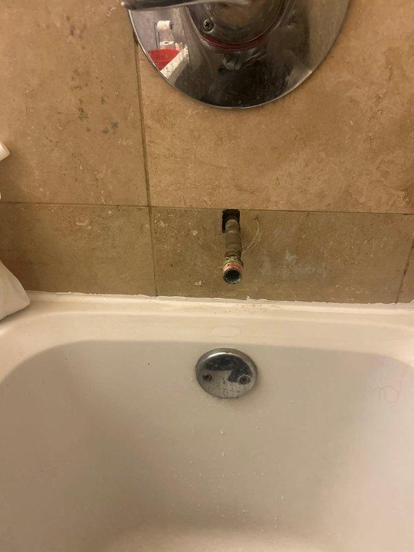 Responded to service call for shower repair. Removed corroded tub spout and replaced shower diverter valve which showed significant mineral buildup and internal corrosion. Additionally repaired sink drain to restore proper functionality.