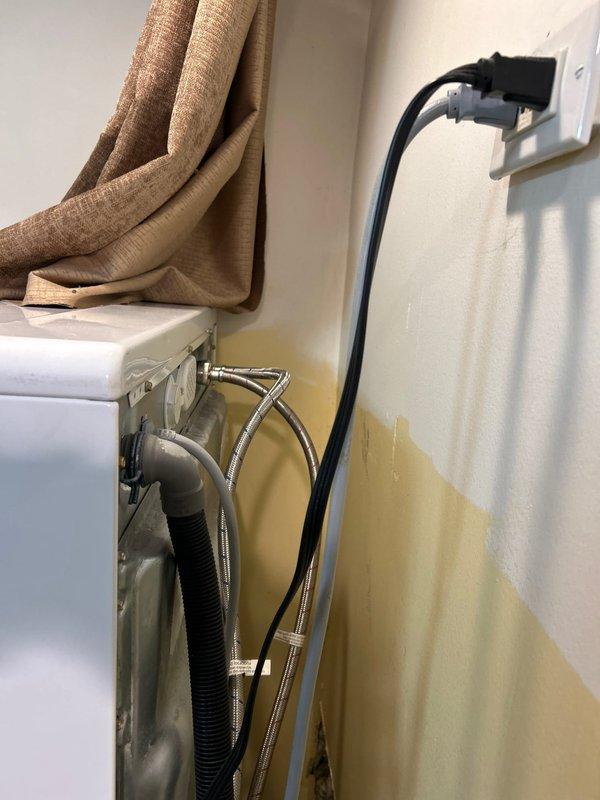 Responded to service call for leaking washing machine supply line. Upon inspection, discovered aged and corroded metal pipe connections with visible water damage on adjacent wall. Replaced the deteriorated supply hoses with new braided metal lines, properly secured all fittings, and tested system to confirm complete resolution of leak.