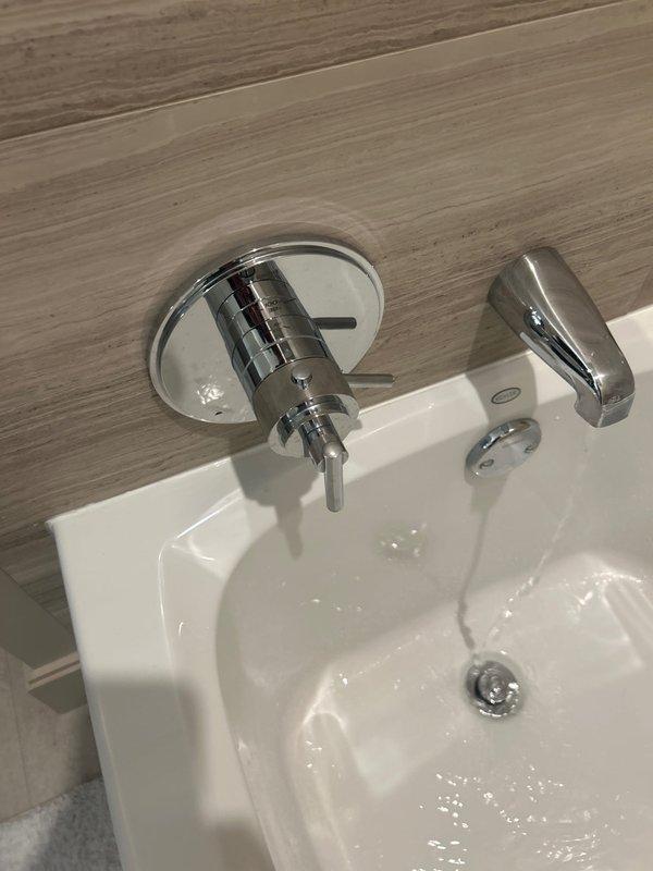 Diagnosed low hot water pressure issue in shower fixture. Inspection revealed normal cold water flow but restricted hot water flow causing trickle effect. Verified sink fixtures functioning properly with adequate water pressure. Recommended replacement of shower valve cartridge to restore proper hot water flow.