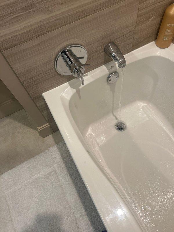 Diagnosed low hot water pressure issue in shower fixture. Inspection revealed normal cold water flow but restricted hot water flow causing trickle effect. Verified sink fixtures functioning properly with adequate water pressure. Recommended replacement of shower valve cartridge to restore proper hot water flow.