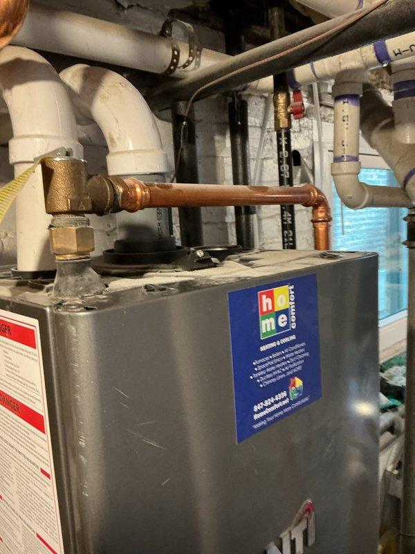 Responded to service call for leaking tankless water heater. Inspected on-demand unit with visible copper connections and shut-off valves. Resolved leak issue and restored proper hot water function. Also performed maintenance on upstairs shower drain using drain rod.