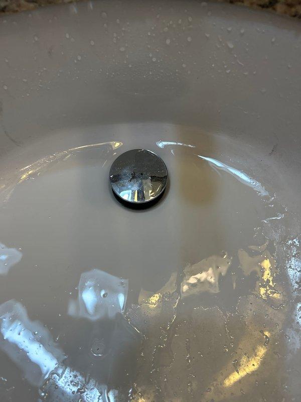 Successfully installed customer-supplied pop-up drain assembly in bathroom sink. Completed full installation with proper connection to existing p-trap and drain system. Verified operation with no leaks upon completion.