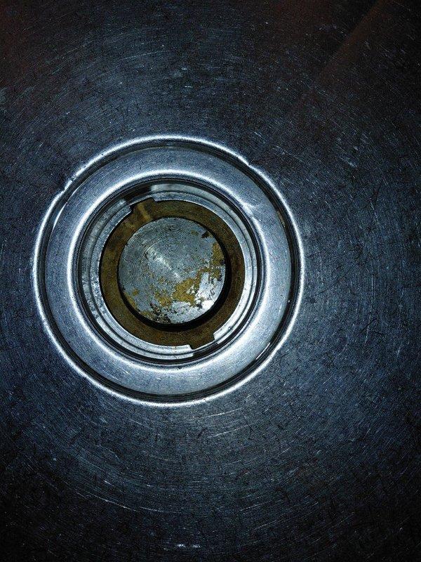 Responded to commercial service call for a leaking 3-compartment sink. Upon inspection, discovered significant corrosion and mineral buildup in the drain assembly with visible oxidation in the central drain opening. Documented condition with detailed photographs for assessment of replacement components.