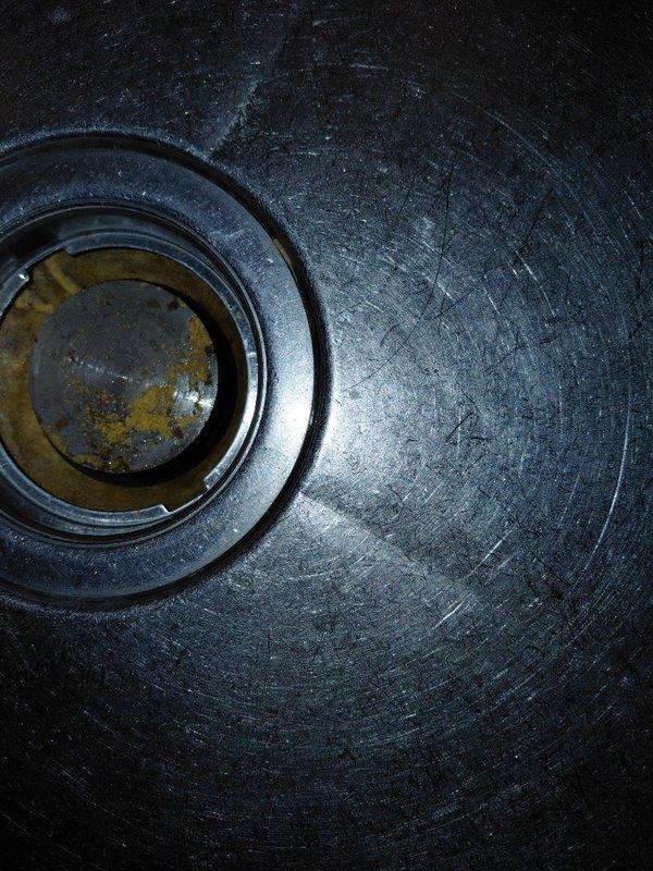 Responded to commercial service call for a leaking 3-compartment sink. Upon inspection, discovered significant corrosion and mineral buildup in the drain assembly with visible oxidation in the central drain opening. Documented condition with detailed photographs for assessment of replacement components.
