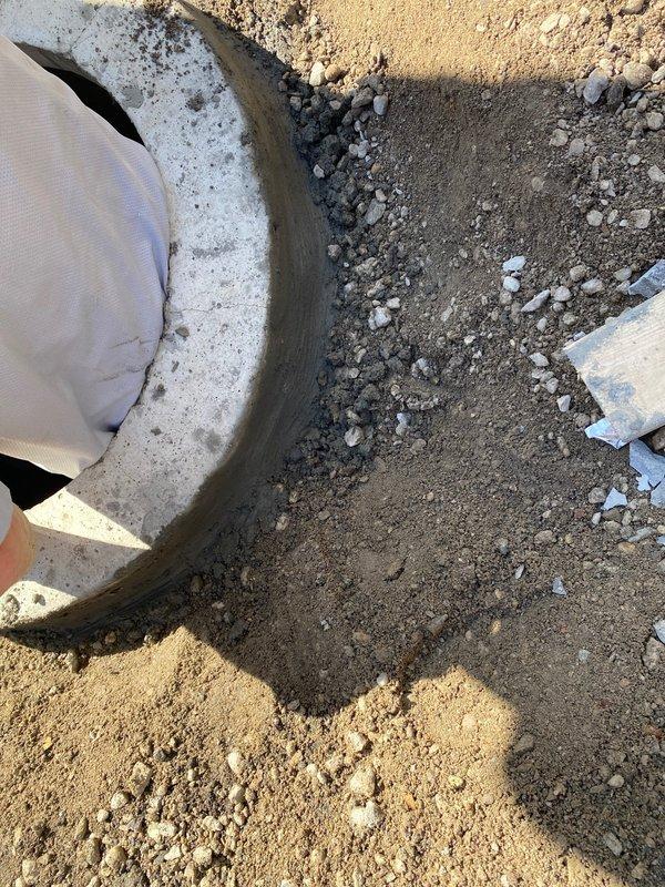 Excavated and exposed existing concrete sewer line for repair work as scheduled. Cleared soil and debris around pipe, documenting condition with photos for proper assessment and completion of the sold repair.