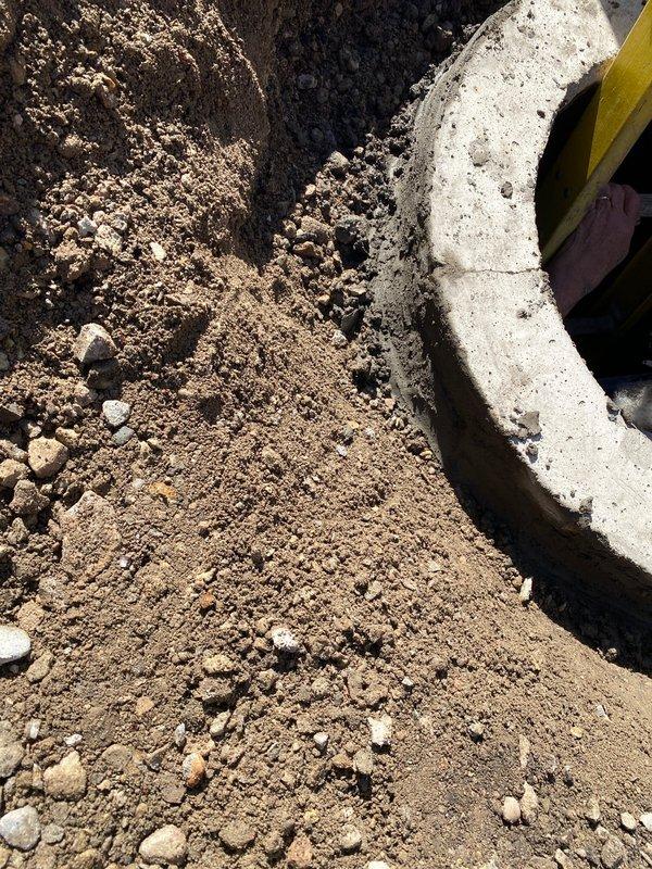 Excavated and exposed existing concrete sewer line for repair work as scheduled. Cleared soil and debris around pipe, documenting condition with photos for proper assessment and completion of the sold repair.