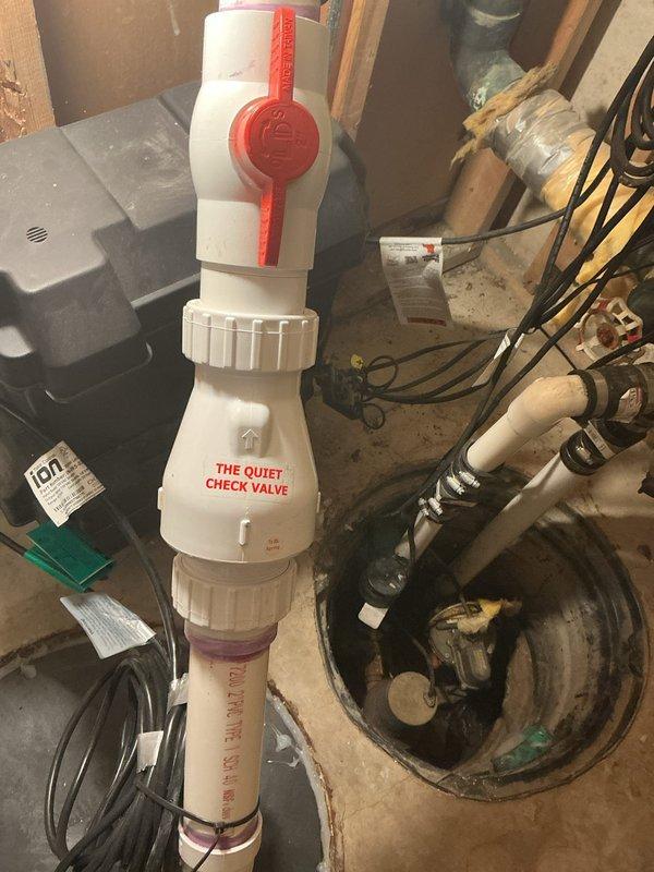 Conducted inspection of customer's water meter piping system. Identified significant corrosion and deterioration on metal pipe junction with T-shaped valve, showing rust and greenish-blue patina. Documented existing Quiet Check Valve installation and noted damaged yellow fiberglass insulation surrounding portions of the piping system. Provided comprehensive estimate for replacement of corroded components to prevent potential future leaks.