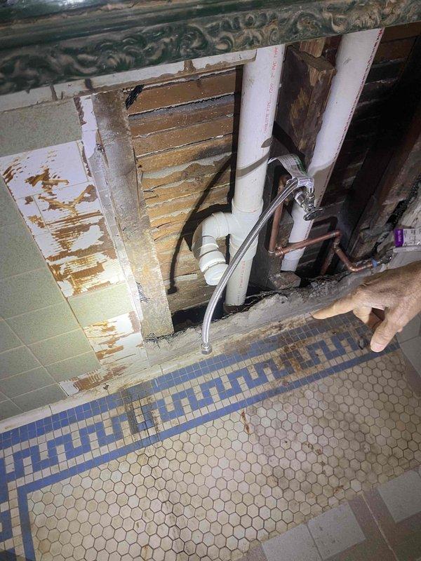 Responded to water leak in basement affecting ceiling and bathroom wall. Located source of leak in corroded galvanized and copper pipe connections, causing significant water damage to ceiling drywall and bathroom wall structure behind tiles. Replaced damaged pipe sections, installed new PVC drain components, and secured all connections to eliminate leakage points.