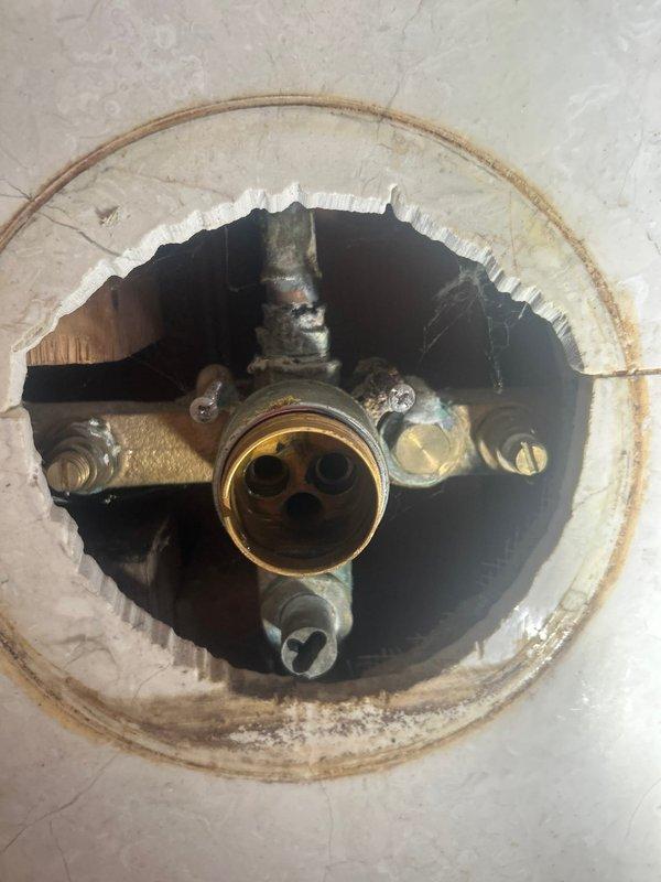 Successfully completed afternoon repair job involving replacement of deteriorated faucet valve assembly. Removed existing brass valve stem with significant corrosion and water damage to surrounding fixture area. Installed new valve assembly with proper hot/cold water indicators, ensuring secure connection to water supply lines and eliminating previous leakage issues.
