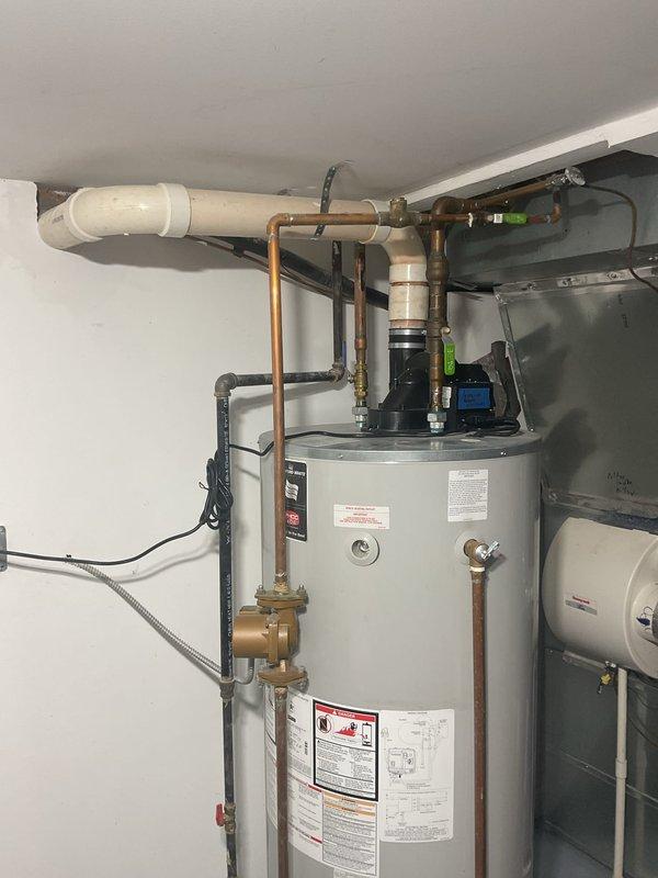 Performed inspection of 75-gallon water heater that is currently operational but exhibiting active leak. Documented damage to flooring at pipe connection point with concrete deterioration evident. Provided customer with multiple replacement options including standard and high-efficiency models.