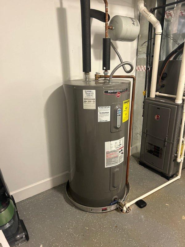 Responded to service call for non-functioning 11-year-old water heater (model R92PRSMA) with no hot water output. Upon inspection of the unit and associated plumbing components in the utility room, diagnosed end-of-life failure requiring replacement. Recommended installation of new water heater to restore hot water service.