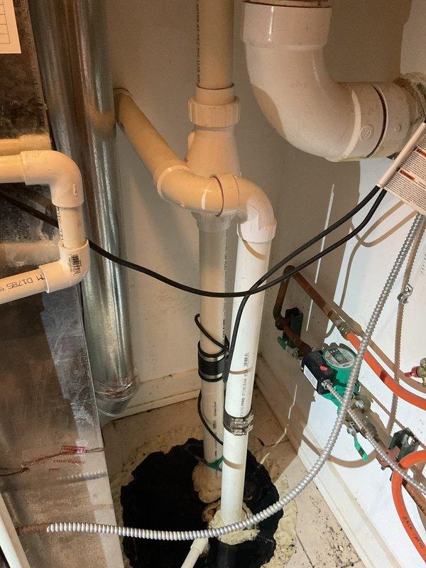 Responded to service call for multiple toilets backing up on lower level with suspected ejector pump issue. Inspection revealed water backup from shower drain and washer drain. Performed diagnostic assessment of the plumbing system, focusing on the PVC drainage network and ejector pump installation. Cleared blockage in main drain line and verified proper operation of all affected fixtures, restoring normal drainage function throughout the system.