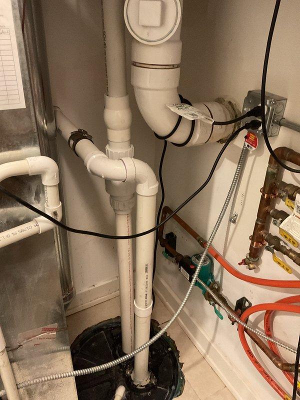 Responded to service call for multiple toilets backing up on lower level with suspected ejector pump issue. Inspection revealed water backup from shower drain and washer drain. Performed diagnostic assessment of the plumbing system, focusing on the PVC drainage network and ejector pump installation. Cleared blockage in main drain line and verified proper operation of all affected fixtures, restoring normal drainage function throughout the system.