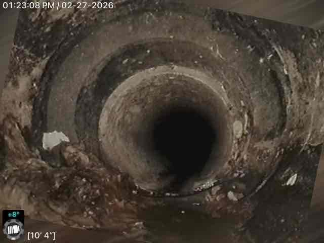 Performed comprehensive camera inspection of sewer line, documenting significant buildup of debris and mineral deposits at distances of 10'4" and 11'9" from access point. Replaced compromised underground pipe section causing blockages and successfully cleaned basement sink line to restore proper drainage function.