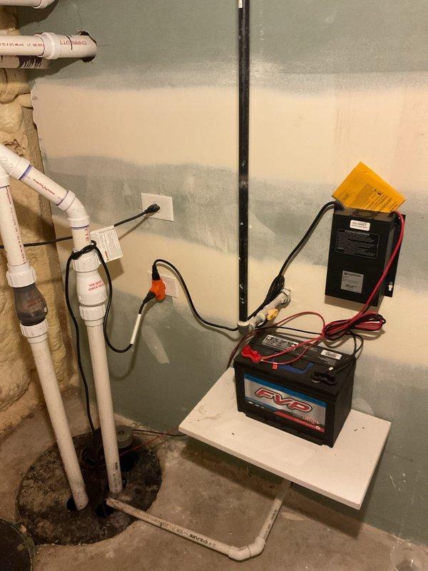 Responded to service call regarding sewer odor emanating from bathroom shower drain. Upon inspection, examined the home's plumbing system including the basement drainage setup with PVC pipes, check valve, and battery backup sump system. Also inspected water heater installation with associated copper piping and P-trap configuration to identify potential causes of the reported sewer smell.