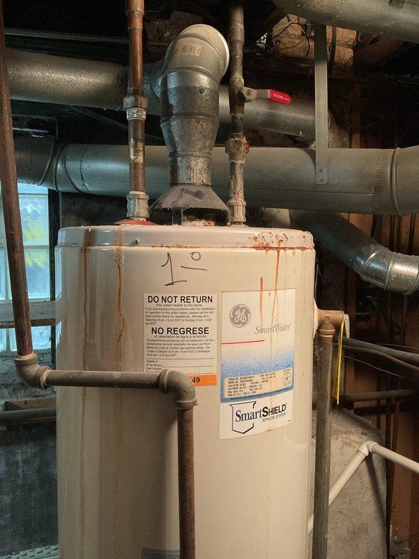 Conducted on-site assessment of leaking water heater. Inspected existing GE SmartWater unit showing significant rust staining and deterioration along top edge. Provided replacement estimate for new Bradford White water heater, including necessary copper pipe reconnections, vent pipe installation, and proper drainage setup to resolve current leakage issue.