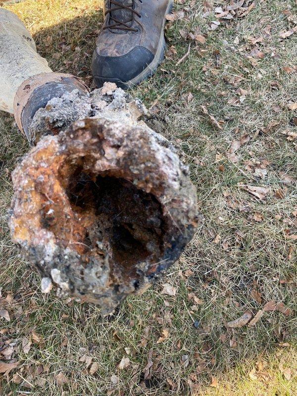 Completed inspection of residential sewer line system, documenting severely corroded metal pipe requiring replacement. Assessed basement utility area where new PVC connections will be installed, noting existing plumbing configuration and access points. Installation crew scheduled to return Monday to perform full sewer line replacement as approved by customer.