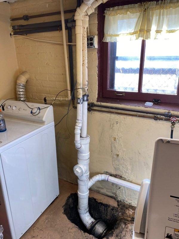 Completed inspection of residential sewer line system, documenting severely corroded metal pipe requiring replacement. Assessed basement utility area where new PVC connections will be installed, noting existing plumbing configuration and access points. Installation crew scheduled to return Monday to perform full sewer line replacement as approved by customer.