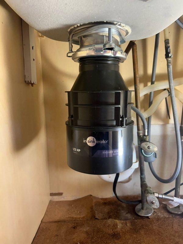 Responded to service call regarding water backup occurring during garbage disposal operation. Upon inspection of the InSinkErator Badger 1/2 HP unit, diagnosed a clog in the drain line causing water to back up when disposal was activated. Successfully cleared blockage in the drainage system, tested operation with multiple disposal cycles, and confirmed proper drainage with no further backup issues.