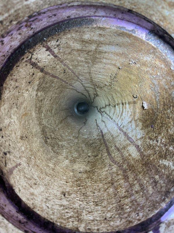 Responded to callback request to televise main sewer line. Inspected the area around the foundation where access point was located, and performed camera inspection of the sewer pipe. Images revealed circular concentric rings along the pipe interior with visible moisture/condensation and some mineral deposits, suggesting potential scaling or root intrusion narrowing the pipe diameter toward the outlet.