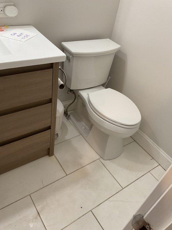 Responded to service call for slow-draining toilet with occasional bubbles and sewer odor in lower level bathroom. Performed diagnostic inspection, removed toilet to check flange height and replaced wax seal. Successfully cleared blockage in branch line using drain auger, removing significant hair and debris accumulation. Reinstalled toilet with proper seal and verified proper drainage function.