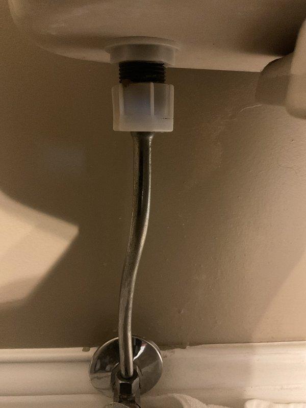 Responded to a service call for a leaking toilet supply line connection. Inspected the braided stainless steel line connected to the chrome shutoff valve and identified the source of the leak. Replaced the faulty supply line and tested the connection for proper function and absence of leaks.
