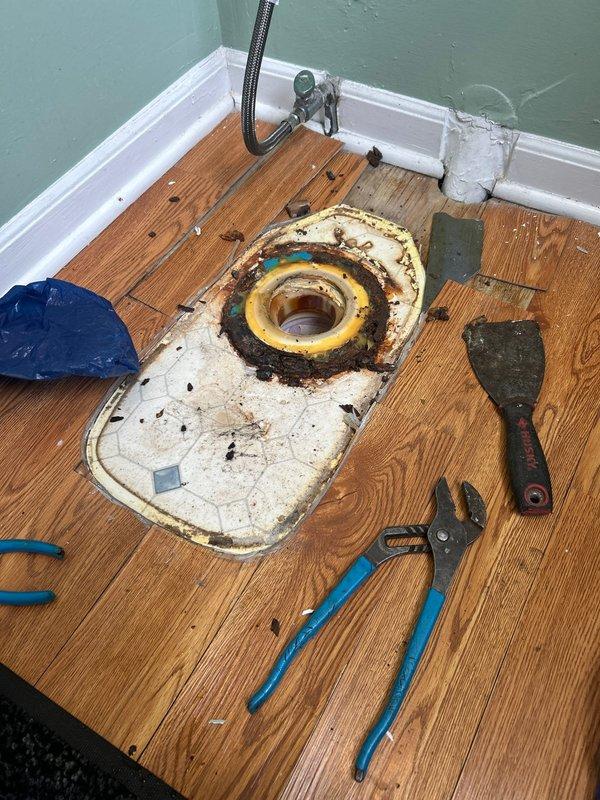 Responded to service call for a continuously running toilet that was flagged by city water meter. Upon inspection, discovered significant water damage to subfloor surrounding the toilet flange. Removed toilet, cleared deteriorated wax ring and debris from flange area, and installed new toilet with proper sealing to prevent future leakage. Confirmed proper operation and water flow cessation when not in use.