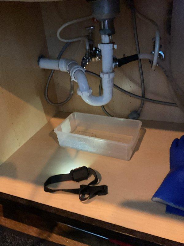 Responded to service call for clogged kitchen sink that customer had previously attempted to clear by cleaning P-trap and snaking. Upon inspection of the under-sink plumbing system, identified blockage beyond the P-trap in the drain line. Successfully cleared obstruction using professional-grade drain cleaning equipment, restoring proper drainage function.