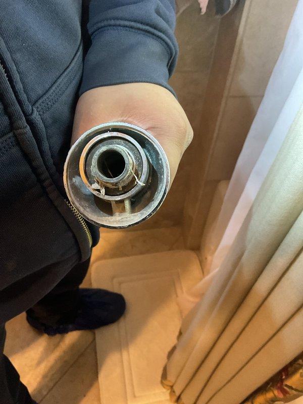 Responded to service call regarding detached bathtub spigot. Upon inspection, discovered the circular mounting collar had separated from the wall, causing the entire faucet assembly to disconnect. Installed new mounting hardware and secured replacement chrome tub spout with proper diverter functionality, restoring normal operation.