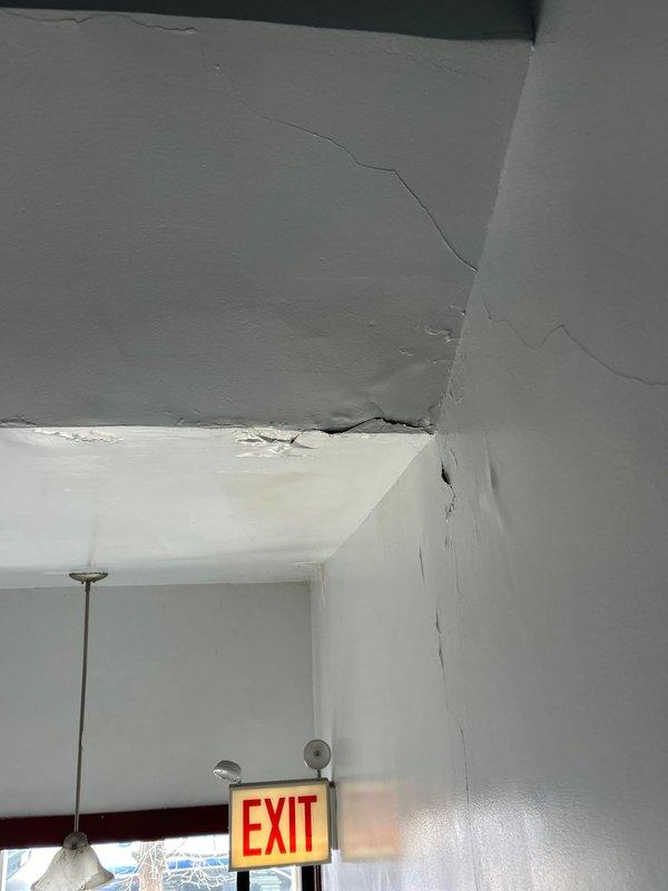 Investigated toilet leak reported to be affecting lower floor bathroom. Upon inspection, discovered significant water damage in ceiling and wall cavity below the toilet. Removed damaged drywall section to expose compromised wooden structural members showing signs of extensive water damage and deterioration. Documented damage with photos for further assessment and repairs.