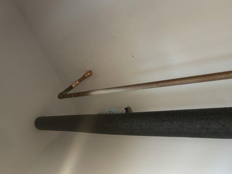 Arrived on site and collected payment as pre-arranged for the sold repair. Completed installation of copper supply line with proper elbow joint connection alongside insulated black pipe system. Installed access panel on adjacent wall for future servicing of the plumbing components.