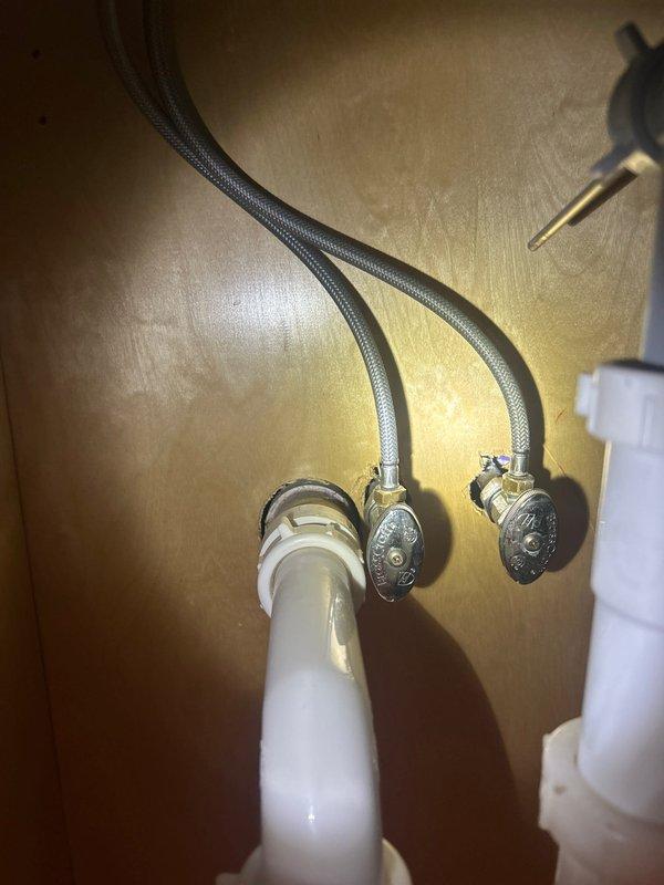Completed shower valve replacement and installed new shut-off valves under sink. Inspected existing plumbing system including copper supply lines, PVC drainage components, and braided stainless steel water lines. Replaced worn cartridge to restore proper function and prevent future leaks.