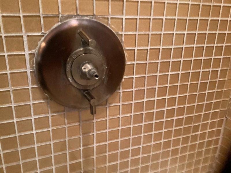 Performed replacement of deteriorated shower valve cartridge with significant mineral buildup. Removed old cartridge showing discoloration and sediment accumulation, and installed new compatible cartridge to restore proper water flow and temperature control functionality in the shower system.