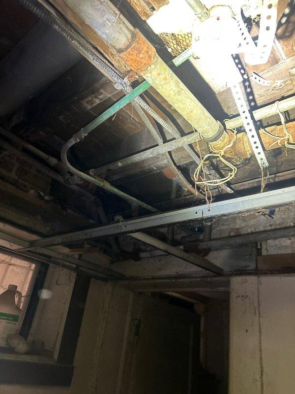 Responded to customer complaint regarding non-functioning bathtub faucet. Upon inspection of the plumbing access area, identified severe corrosion on copper supply lines and improper installation of previous plumbing components. Replaced deteriorated piping sections, installed new faucet valve assembly, and tested water flow to ensure proper operation and no leaks.