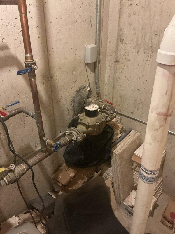 Conducted comprehensive inspection for potential sump pump installation in basement utility area, assessing existing water meter assembly and associated copper/PVC piping configuration. Also evaluated bathroom shower system with oil-rubbed bronze fixtures and provided estimate options for addressing all plumbing concerns per client request.