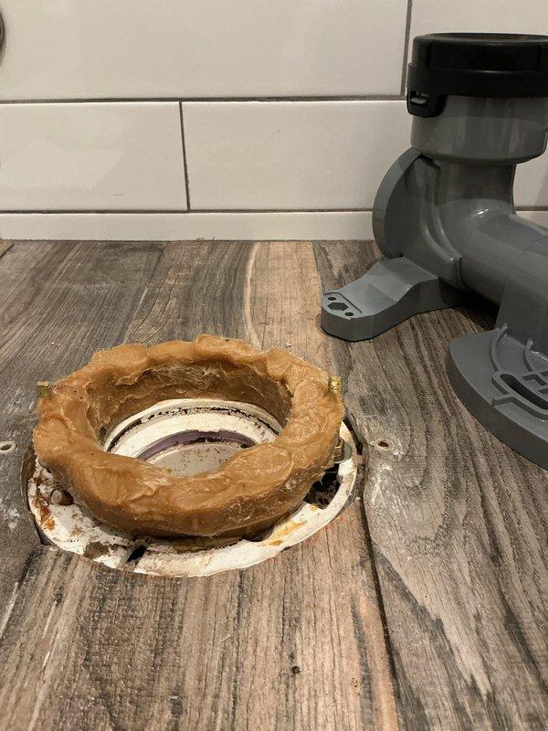 Completed installation of customer-supplied bidet toilet. Upon removal of old fixture, discovered aged and degraded wax ring with significant discoloration and rust stains around the toilet flange. Cleaned mounting area, replaced wax ring, and properly secured new bidet toilet to existing flange using brass mounting bolts. Tested for proper function and verified no leaks.