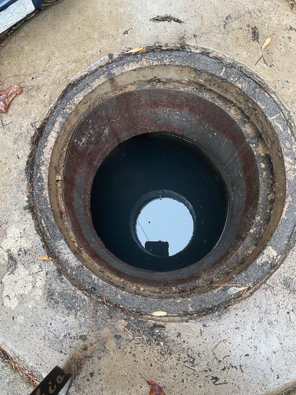 Inspected basement flooding issue reported by customer. Located main sewer access point showing significant corrosion and rust on the metal pipe insert. Rodded the line to clear blockage causing water backup into basement.