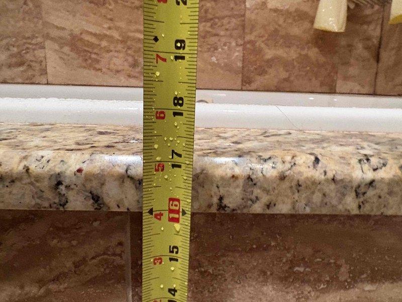 Responded to emergency bathroom leak in 50-year-old residential property. Upon inspection, identified water seepage around sink basin where countertop meets wall tile. Removed affected section of granite countertop, replaced deteriorated caulking and sealed junction points, then reinstalled countertop with proper waterproof barrier to prevent future moisture intrusion.
