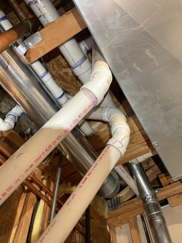 Completed service job involving drain cleaning with rodding and camera inspection of plumbing system. Examined exposed copper supply lines showing oxidation and PVC drainage pipes with proper primer application in wall cavity. Inspected basement drainage infrastructure with focus on PVC piping connections and alignment with existing galvanized ductwork.
