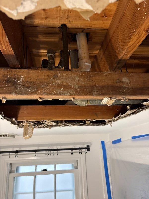 Completed repair of corroded pipe joints in ceiling area as scheduled. Exposed plumbing system by removing damaged ceiling material to access failed connections between metal pipes running across wooden joists. Replaced deteriorated sections and restored proper function to the plumbing system.