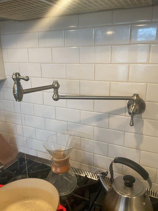 Conducted water leak investigation at customer's request due to high water bill. Inspected two toilets with suspected faulty flappers (customer-supplied replacements), examined kitchen area including pot filler faucet installation, and assessed water heater system for possible leaks. Rodded multiple drain pipes to ensure proper drainage. Replaced kitchen faucet with customer-supplied fixture.