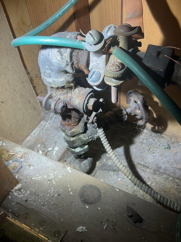 Inspected water line from home to street as requested by customer. Observed significant corrosion and mineral deposits on main valve assembly at connection point, with deteriorated metal components throughout. Evaluated existing PEX piping system and pressure regulating components for potential replacement, documenting current condition to prepare comprehensive estimate for complete water service line replacement.